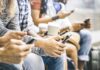 Group of people sitting and using smartphones