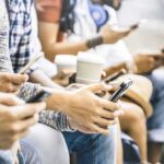 Infinite Scroll’s Nasty Side Effects Group of people sitting and using smartphones