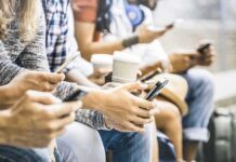 Infinite Scroll’s Nasty Side Effects Group of people sitting and using smartphones